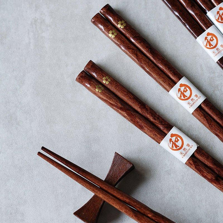 Set of 5 pairs of elegant wooden chopsticks featuring a beautiful golden cherry blossom design, ideal tableware.