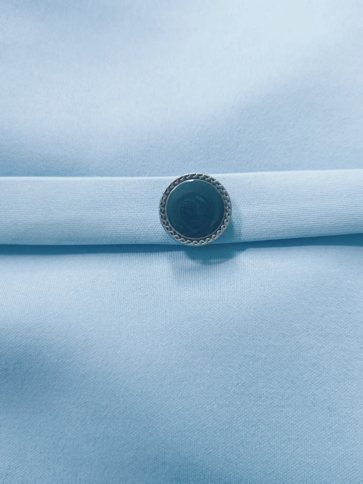 Chic light blue midi dress with a flattering belted waist, V-back detail, and turn-down collar. Great for work or events.