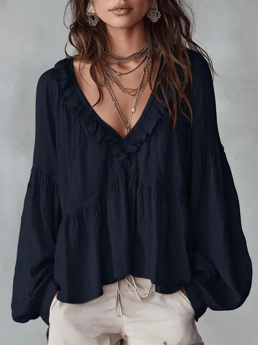 Black women's puff sleeve ruffle top with deep V-neck. Versatile elegant or casual long sleeve blouse.