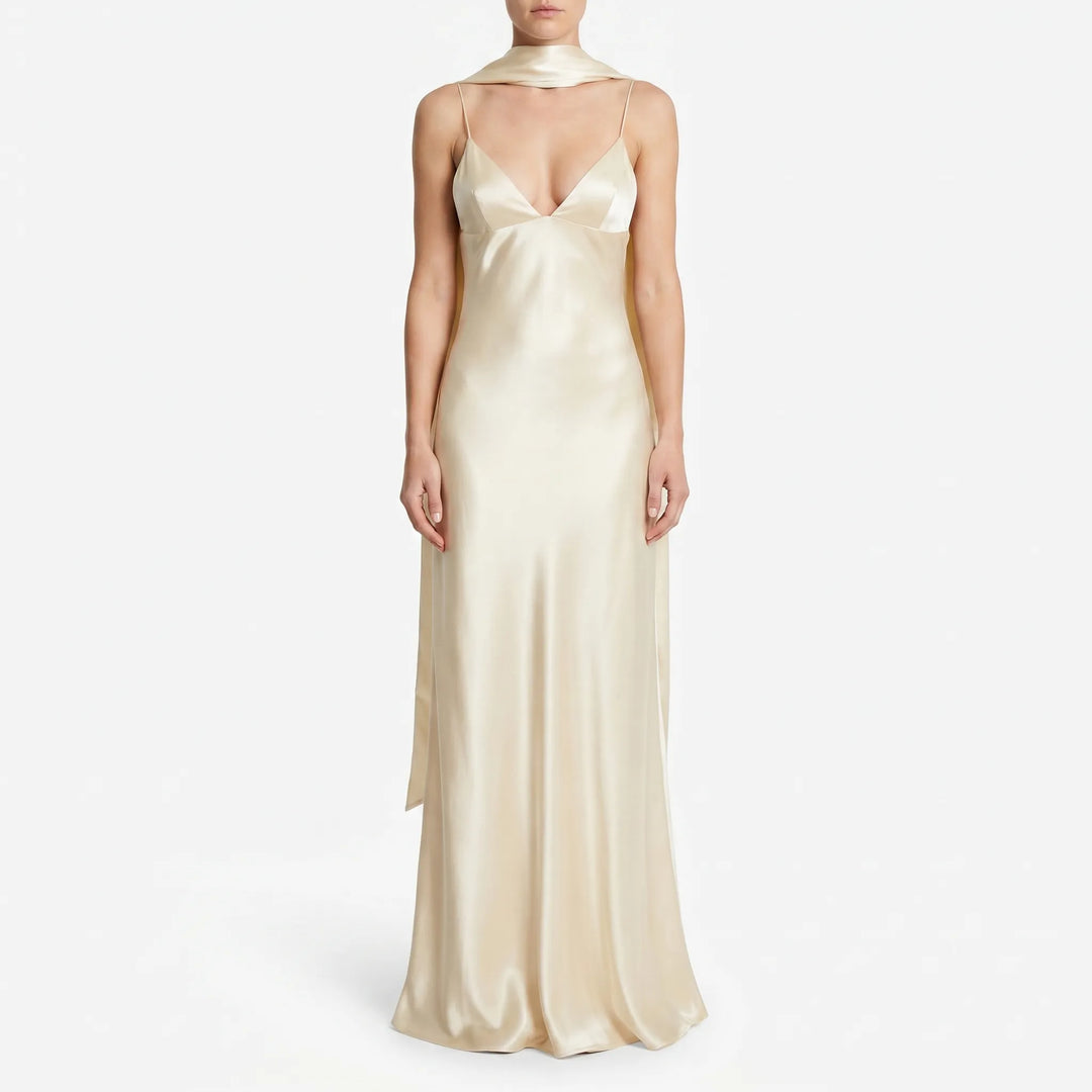 Women's elegant light yellow midi slip dress with open back and stylish scarf detail, ideal for cocktail parties.