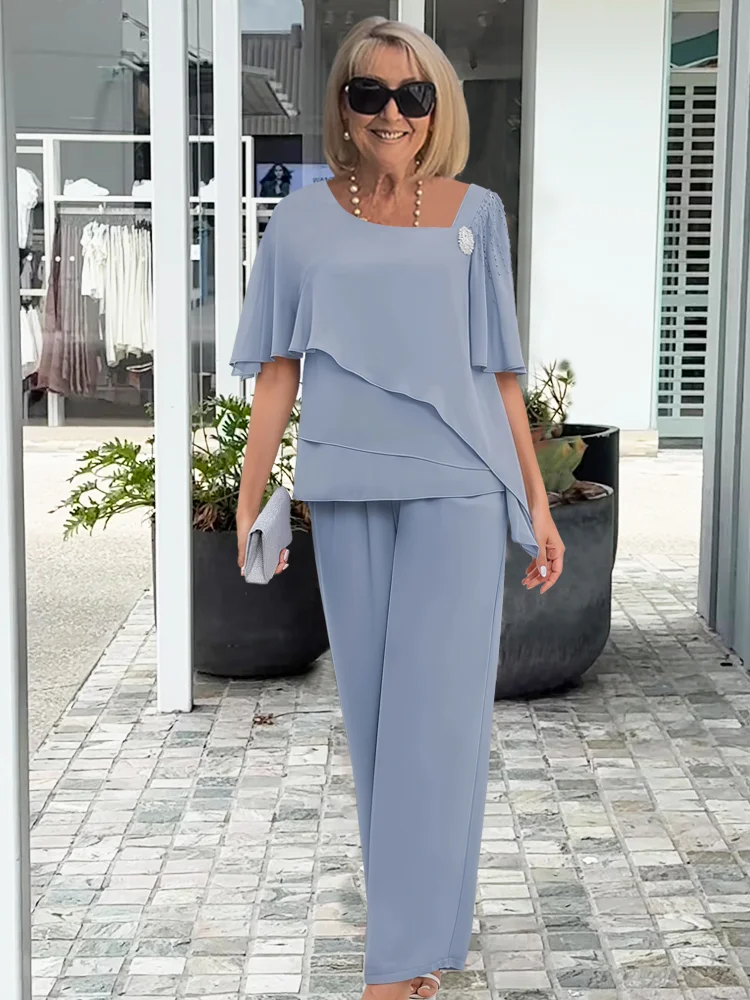 Elegant navy blue women's 2-piece set with overlay top & straight-leg pants. Perfect for sophisticated style.
