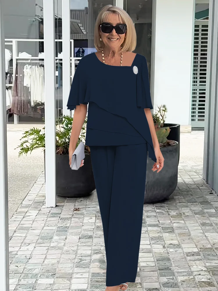 Women's comfortable navy blue overlay top and straight-leg pants set. Versatile for casual chic or formal wear.