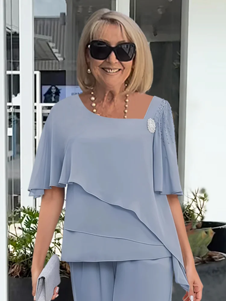 Matching women's navy blue outfit: elegant overlay top & straight-leg pants set. Sophisticated two-piece fashion.