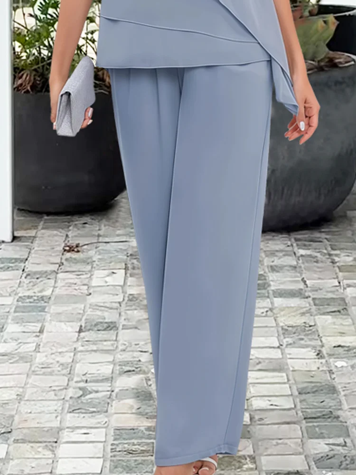 Blue women's matching set: stylish overlay top & straight-leg pants. Modern elegant two-piece outfit for women.