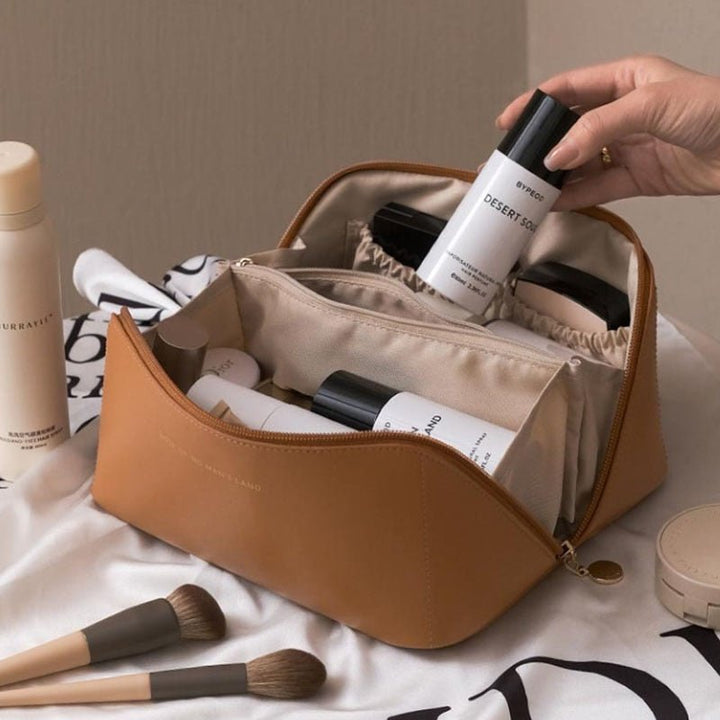Versatile brown travel cosmetic organizer bag, storing women's beauty essentials and makeup accessories.