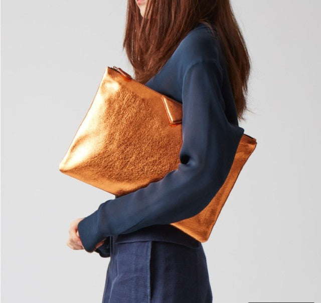 Sophisticated orange vegan leather handbag for women, an elegant purse with a spacious design.