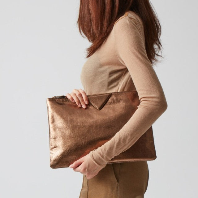 Sleek silver vegan leather shoulder bag for women, a modern fashion accessory with an interior pocket.