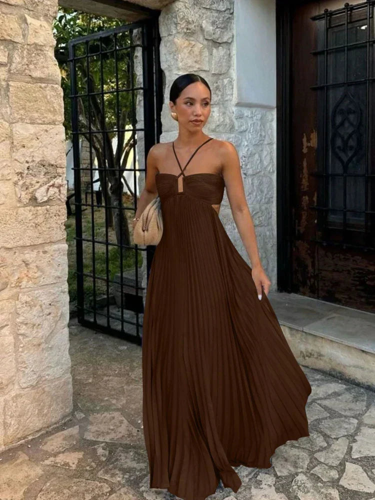 Elegant pleated halter maxi dress with cut-out detail, perfect for wedding guests or formal events.