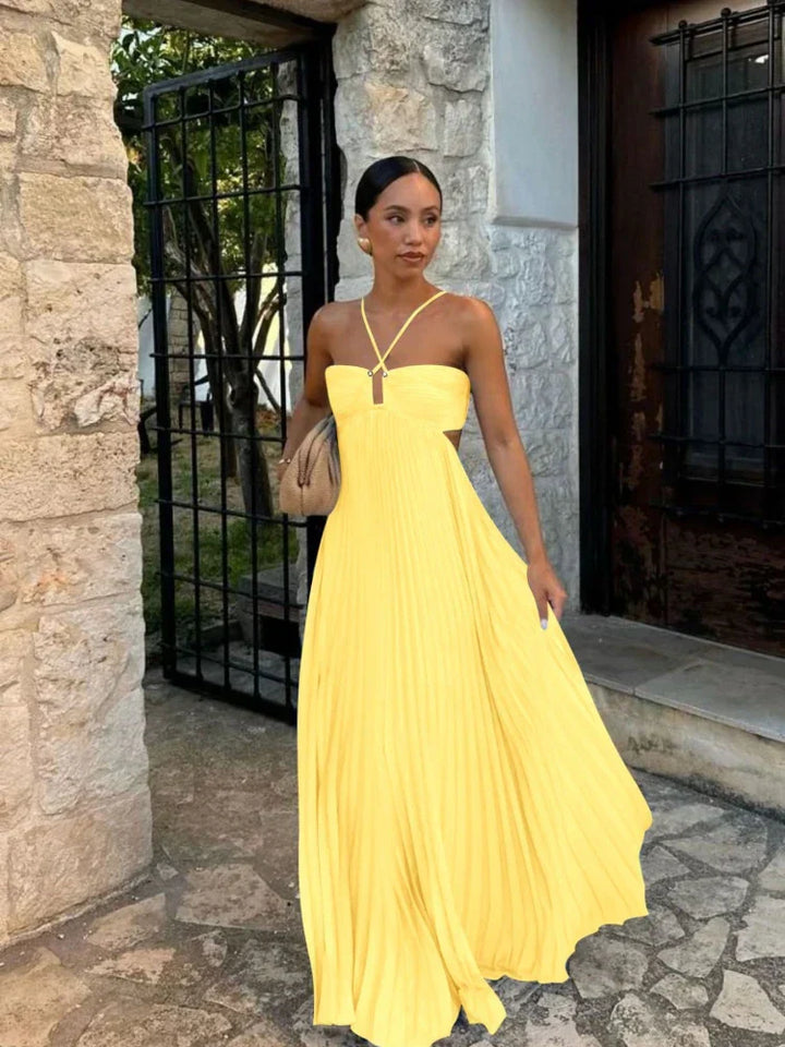Floor-length women's halter maxi dress with stylish pleats & chic cut-outs, ideal for special occasions.