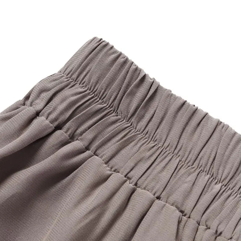 Assortment of plus-size wide-leg work pants in various colors for chic office fashion.