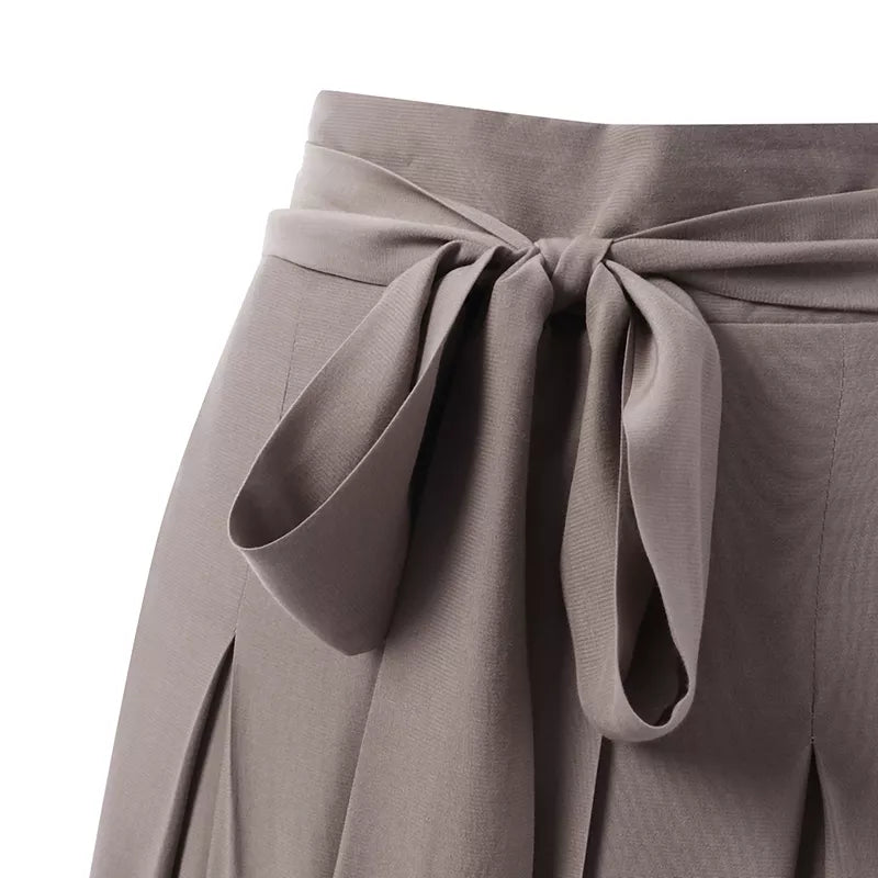 Flat lay of elegant plus-size wide-leg formal trousers, ready for professional wear.