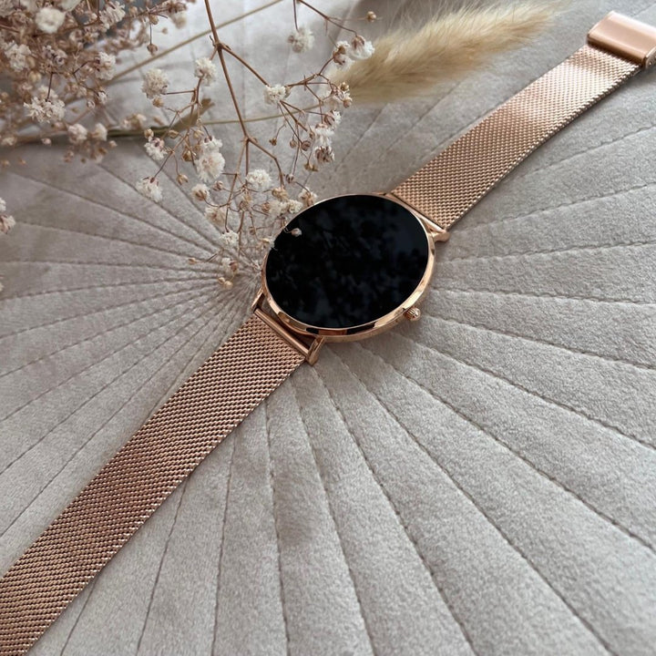 Rose gold women's smartwatch with crisp display. Fitness tracker, wellness monitor & stylish wearable tech.