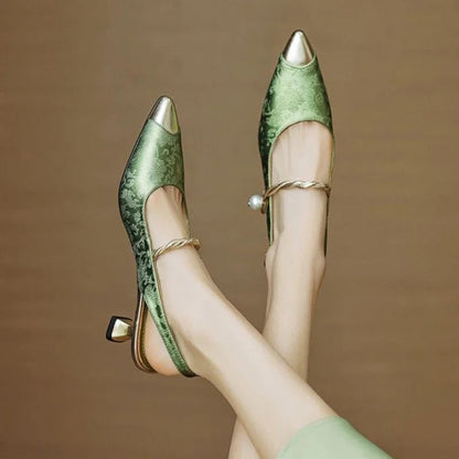Close-up of elegant Savana kitten heels showing delicate pearl accents on the pointed toe dress shoe.