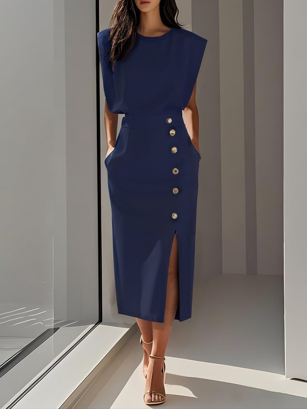 Model in women's sleeveless midi dress with gold buttons, highlighting the elegant side slit detail.