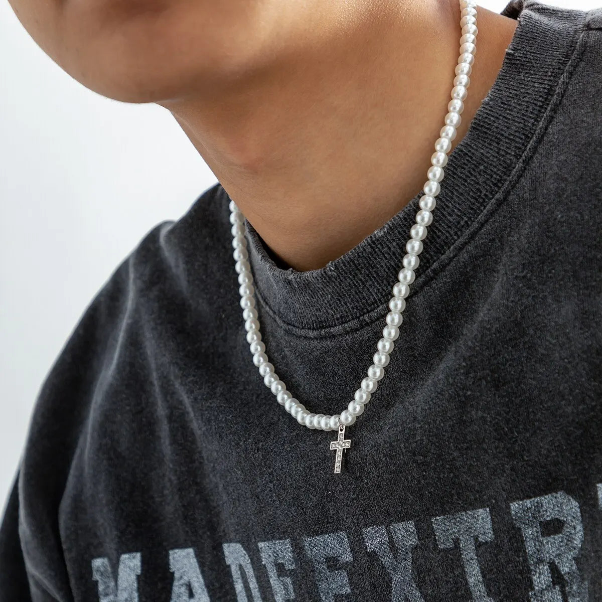 Minimalist unisex pearl necklace featuring an elegant cross pendant, ideal for everyday religious jewelry style.
