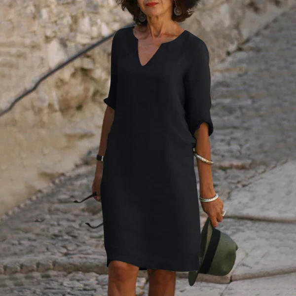 Simple & elegant women's flowy V-neck midi dress with comfortable three-quarter sleeves for daily wear.