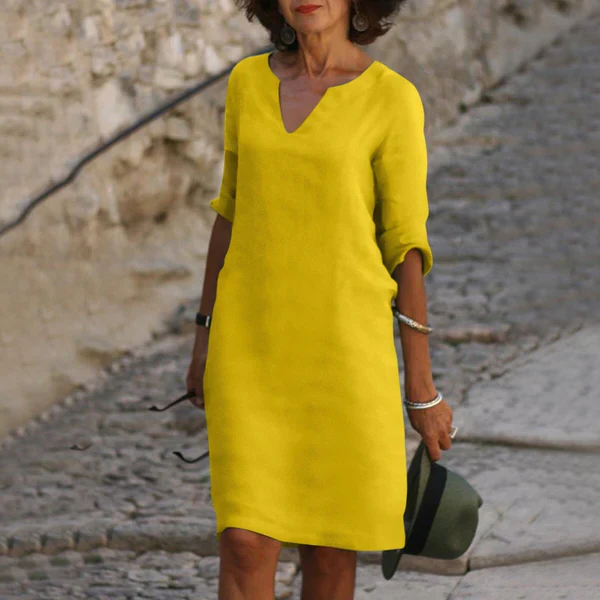 Comfortable & flattering flowy V-neck midi dress for women, featuring elegant three-quarter sleeves.