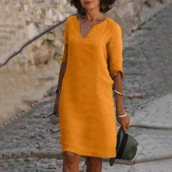 Back view of a women's comfortable flowy V-neck midi dress with elegant three-quarter sleeves, versatile style.