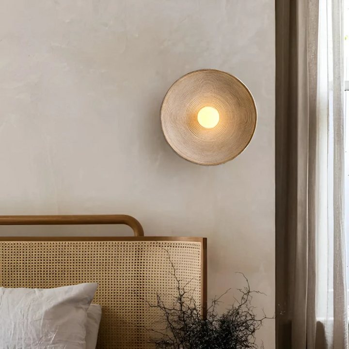 Japanese Wabi-Sabi disc wall lamp providing elegant ambient light, ideal for a serene bedroom or living room.