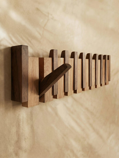 Elegant wall-mounted piano coat rack for home organization & stylish entryway decor.