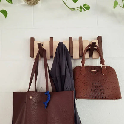 Modern wood piano coat rack, wall mounted, for hats & coats. Sleek & functional entryway decor.