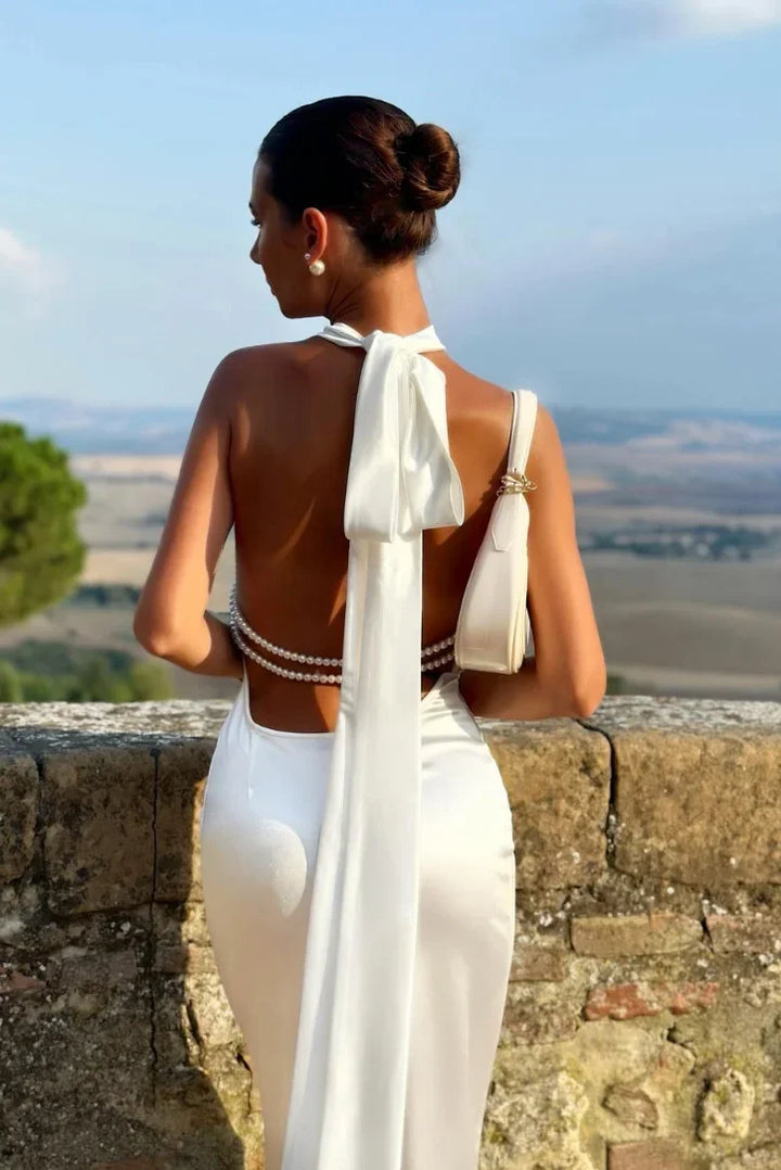 Women's elegant halter backless maxi dress in white, ideal for formal events, parties, or vacation.