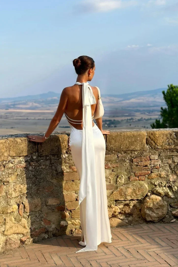 Stylish white backless halter neck maxi dress for women, flattering silhouette, perfect for special occasions.