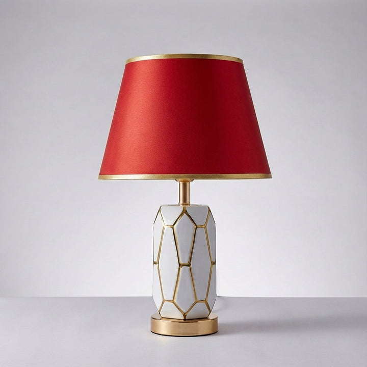 Decorative ceramic base table lamp topped with an elegant fabric shade, perfect for contemporary home decor.