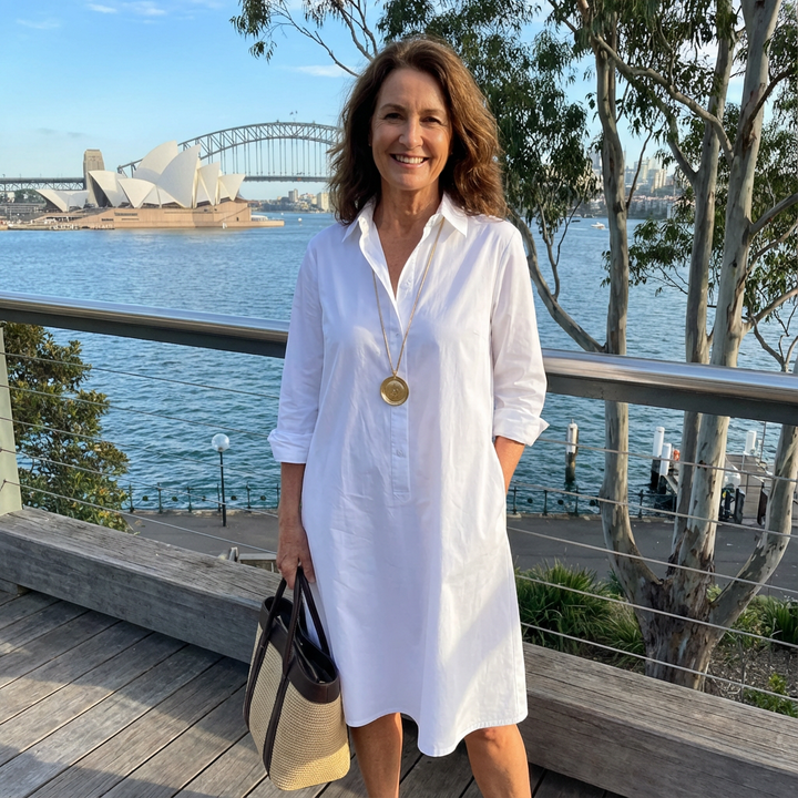 Chic white women's button-down midi dress with collar. Elegant A-line cut, perfect for sophisticated fashion.