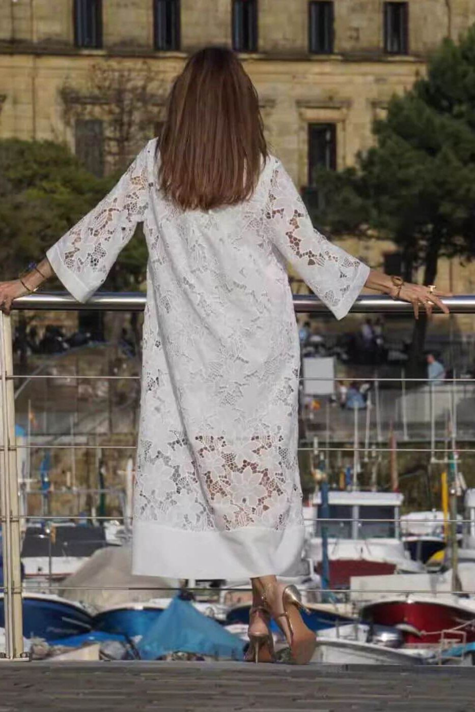 Chic women's flowing maxi dress in a versatile white shade, suitable as a modest summer dress or elegant evening gown.