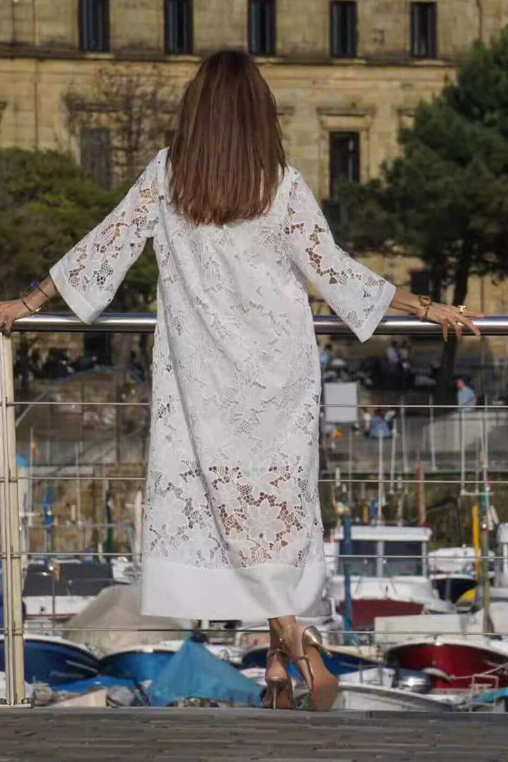 Chic women's flowing maxi dress in a versatile white shade, suitable as a modest summer dress or elegant evening gown.