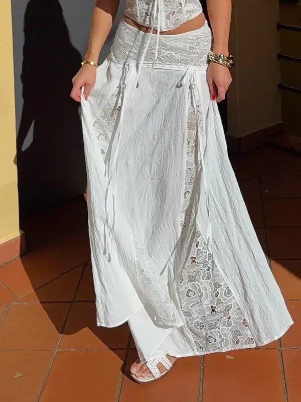 Elegant white women's maxi skirt with delicate lace panels, flowing fabric, perfect for summer fashion.