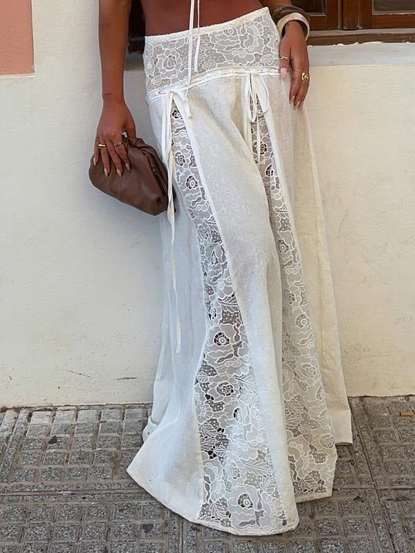 Stylish women's white maxi skirt with elegant lace panels. Flowing fabric for summer fashion & versatile wear.