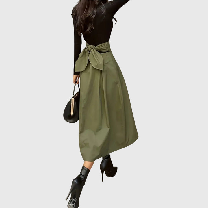 Versatile green A-line midi skirt for women, offering sophisticated style for both casual and office outfits.