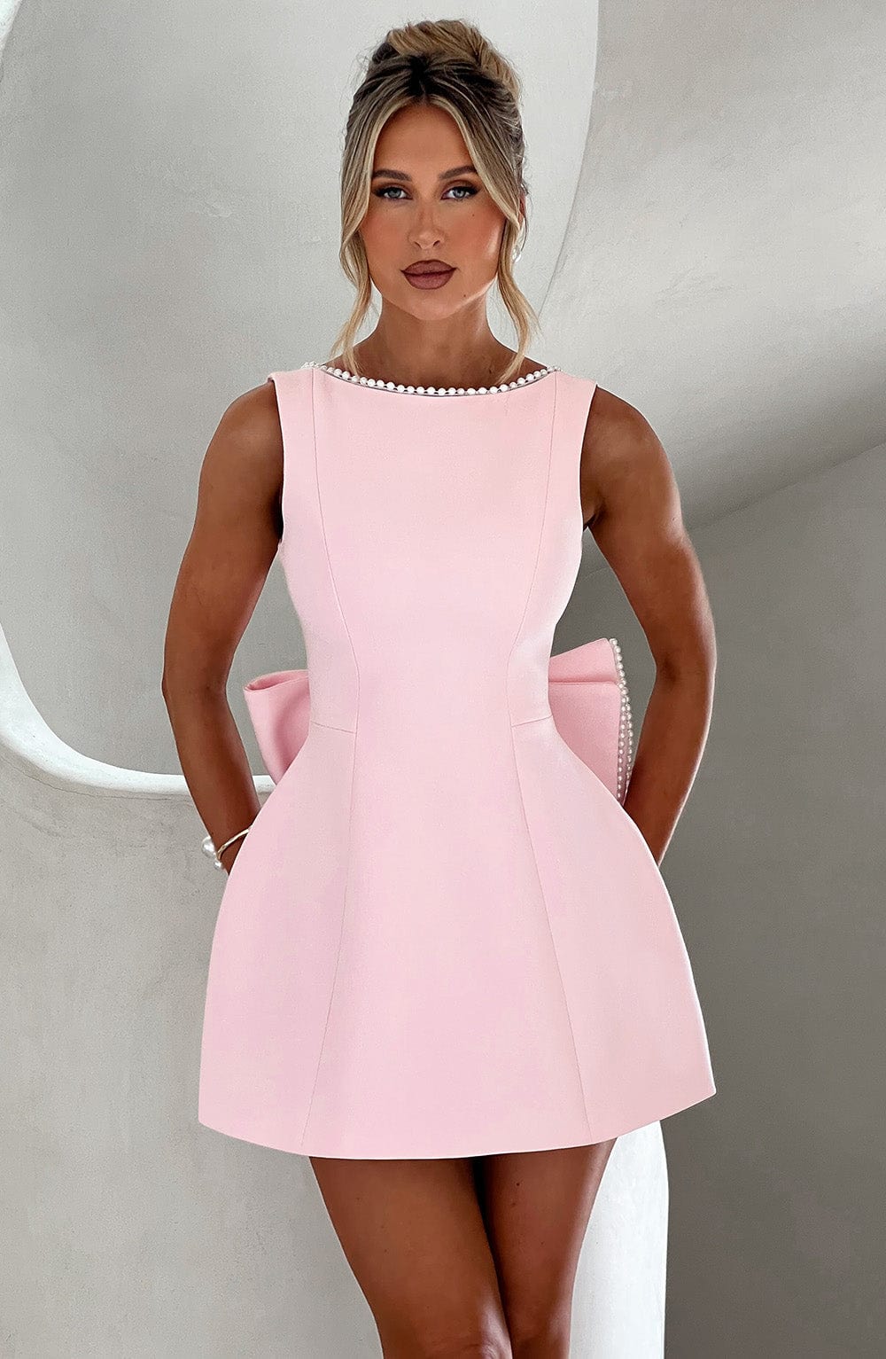 Elegant women's A-line mini homecoming dress with delicate pearl trim, perfect for special occasions.