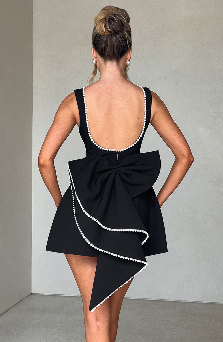 Stunning women's formal mini dress, A-line silhouette, embellished with lustrous pearl trim.