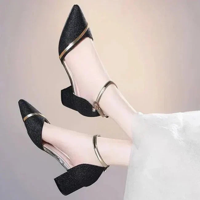 Classic black women's block heel pumps with a stylish ankle strap, ideal for sophisticated fashion.