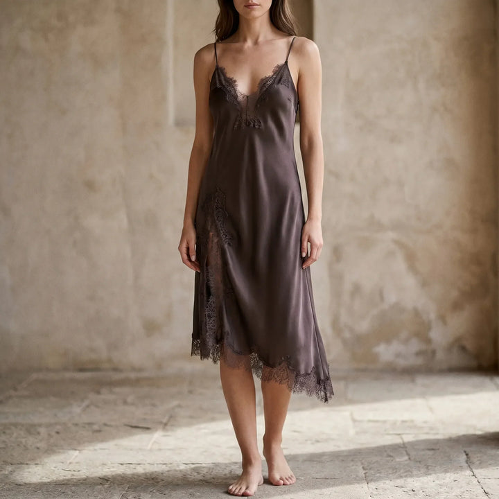 Elegant women's asymmetrical slip midi dress with v-neck and delicate lace trim, perfect for evening occasions.