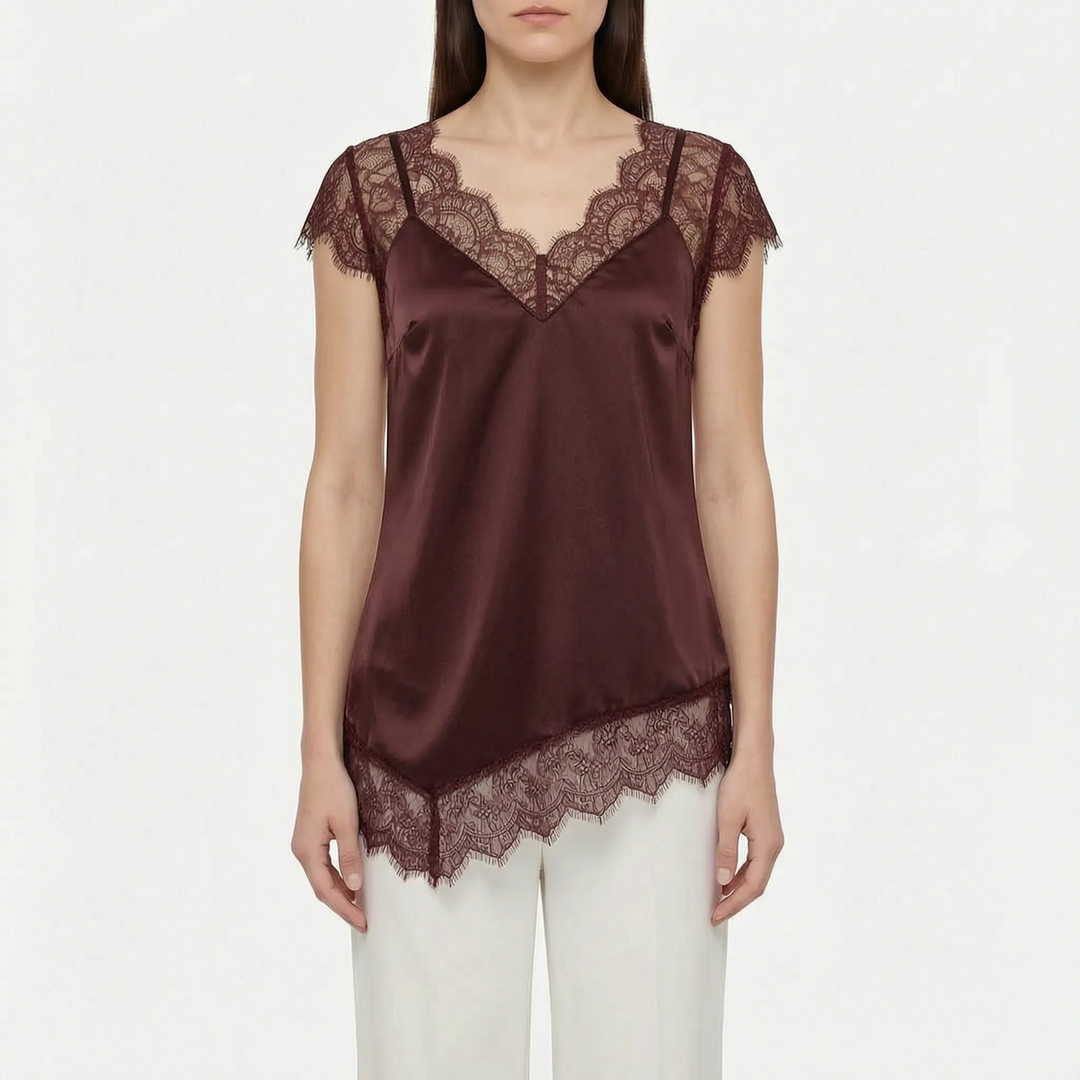 Chic women's top with asymmetrical hem & elegant sheer details. Sleeveless design offers sophisticated summer fashion.