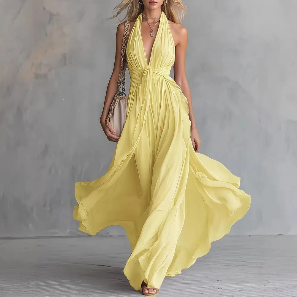 Women's formal halter maxi dress featuring a backless design and elegant pleated side slit, ideal for special occasions.