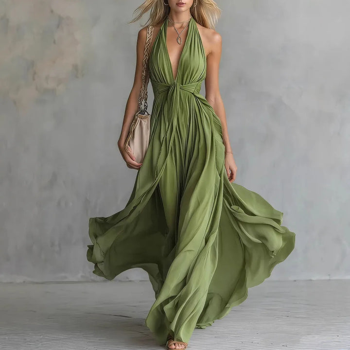 Beautiful women's backless halter maxi dress with pleated side slit, suitable for parties, evening, or vacation.