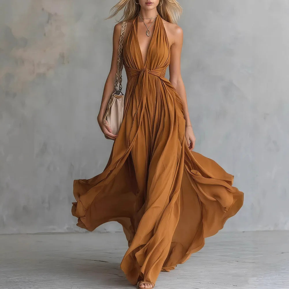 Flowy women's backless halter maxi dress with a sophisticated pleated side slit, great for elegant summer events.