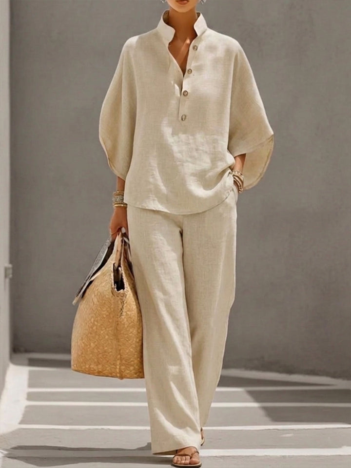 Elegant women's batwing blouse and wide trousers set, a comfortable two-piece outfit for versatile summer style.