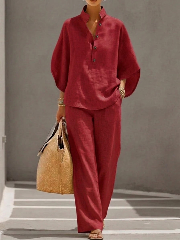 Women's batwing sleeve blouse paired with wide trousers, an elegant two-piece set designed for spring/summer comfort.