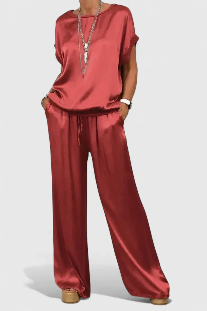 Chic women's two-piece set featuring a batwing sleeve top and flowing wide leg pants for contemporary style.