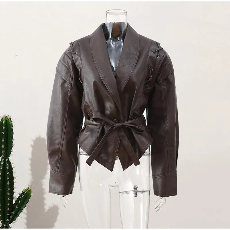 Side profile of elegant women's belted jacket, showcasing tailored fit. Chic outerwear for a flattering silhouette.