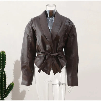 Side profile of elegant women's belted jacket, showcasing tailored fit. Chic outerwear for a flattering silhouette.