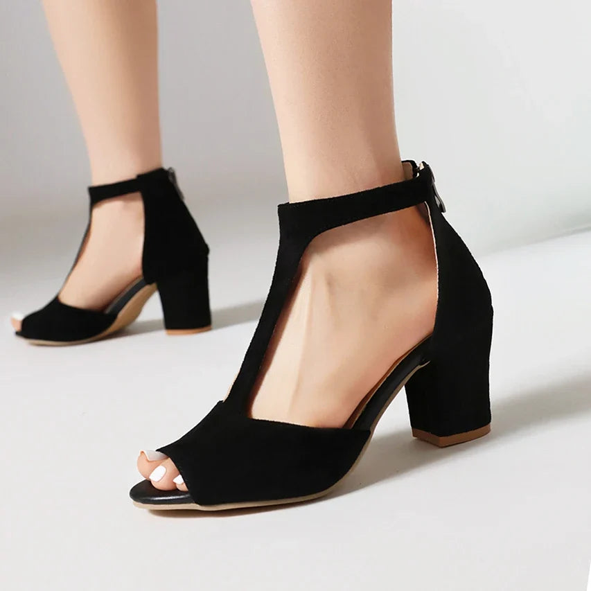 Stable block heel detail of women's comfortable, elegant t-strap shoes. Orthopedic design for all-day wear.