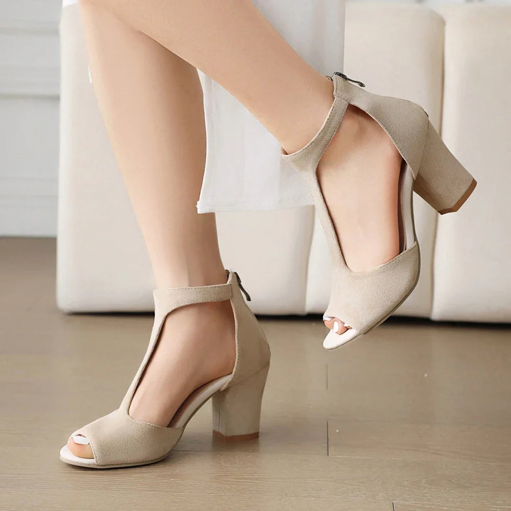 Pair of elegant women's black block heels. Stable, comfortable open-toe t-strap for versatile party & formal wear.