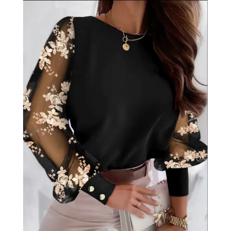 Elegant women's black blouse with sheer long sleeves & delicate floral appliqué. Perfect for party wear or a dressy occasion.